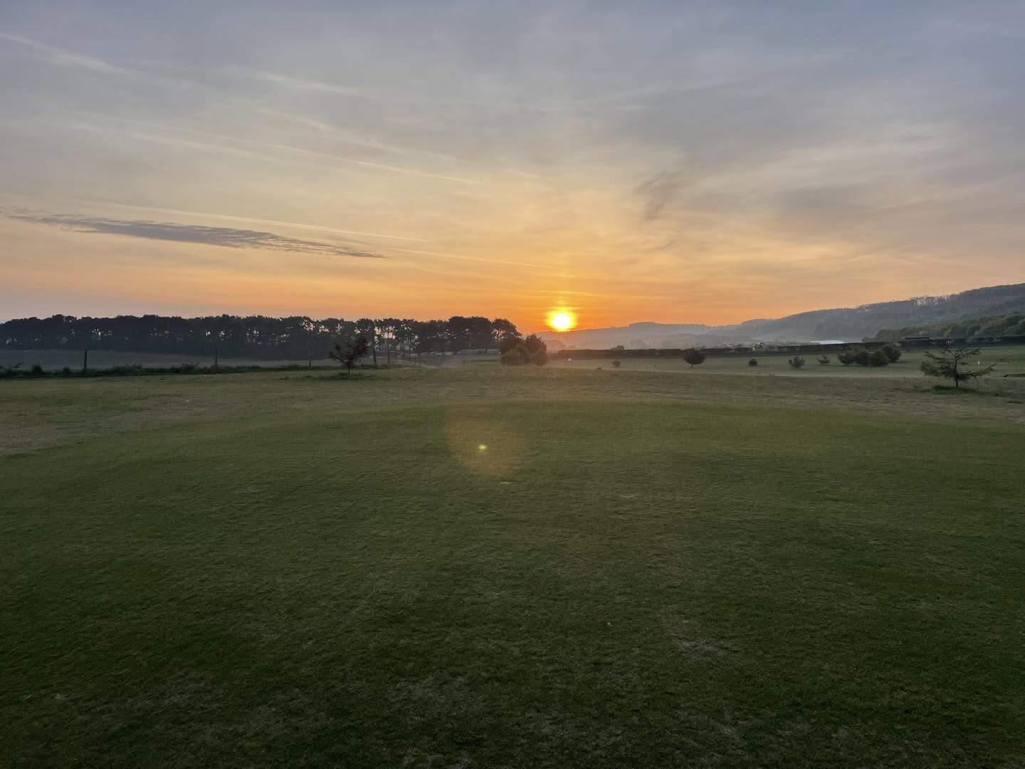 Sunset over a green
