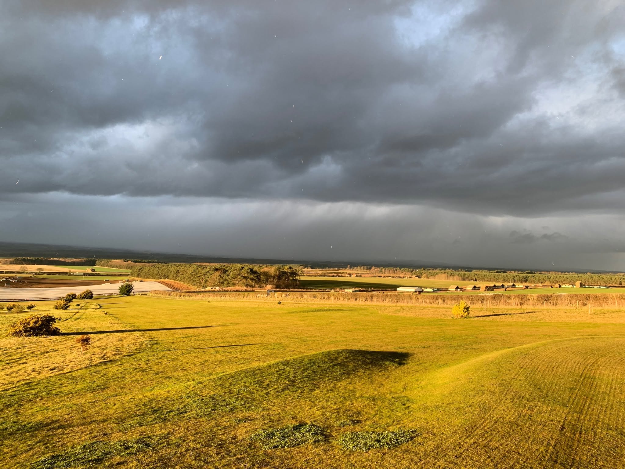 Golden sunshine with tumultuous clouds in the distance
